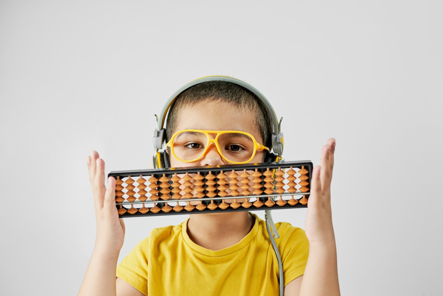 Schoolboy with abacus. Young kid training mental arithmetic